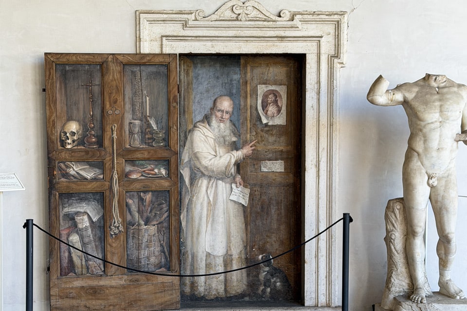 Fresque en trompe-l’œil d’un moine chartreux devant une fausse porte, réalisée par Filippo Balbi dans le cloître des Thermes de Dioclétien à Rome